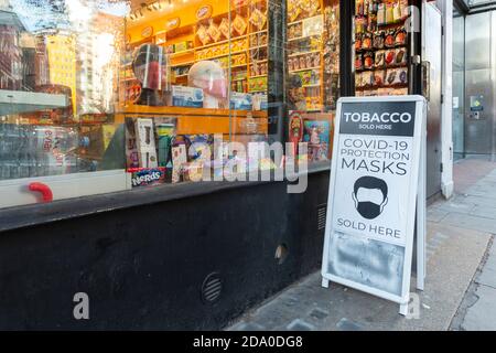 Sign on pavement outside shop advertising COVID-19 protection masks during second national lockdown, London, 7 November 2020 Stock Photo