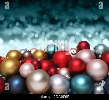 Christmas decorations, pile of glass colored balls isolated on blurred blue bright lights, useful as a greeting gift card background Stock Photo