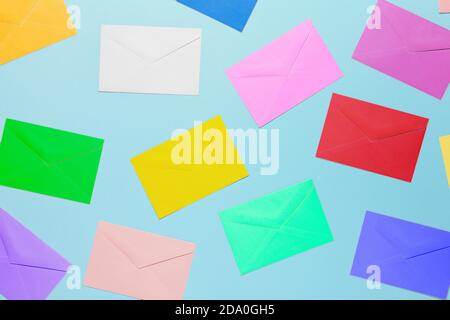 top view image of colorful envelopes on light blue surface, random pattern Stock Photo