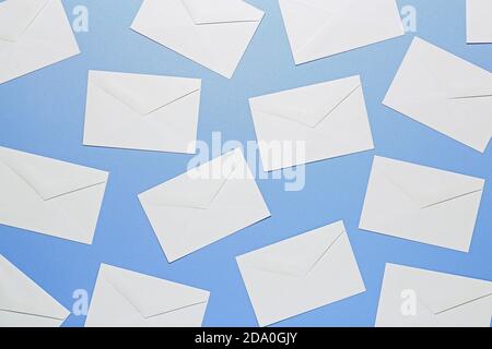 flat lay of white envelopes on blue surface Stock Photo