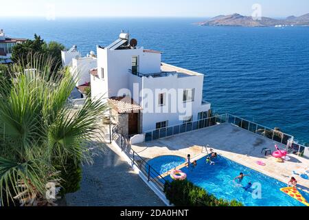 white holiday villas houses on resort with sea view and swimming pool and palm trees Stock Photo