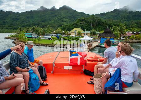 Guest of Paul Gauguin cruise anchored in Huahine island, Society Islands, French Polynesia, South Pacific.   Coastline and lagoon of Huahine island ne Stock Photo