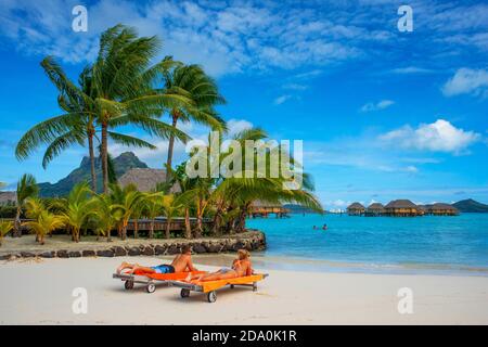 Beach in Le Bora Bora by Pearl Resorts luxury resort in motu Tevairoa island, a little islet in the lagoon of Bora Bora, Society Islands, French Polyn Stock Photo