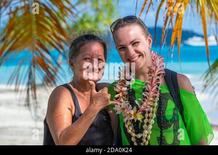 Outdoor portrait of two Tahitian women, older and young. Tevairoa island, a little islet in the lagoon of Bora Bora, Society Islands, French Polynesia Stock Photo