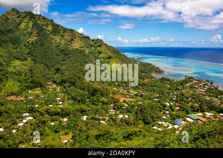 Typical houses, road, and reef see, Moorea island (aerial view), Windward Islands, Society Islands, French Polynesia, Pacific Ocean. Stock Photo