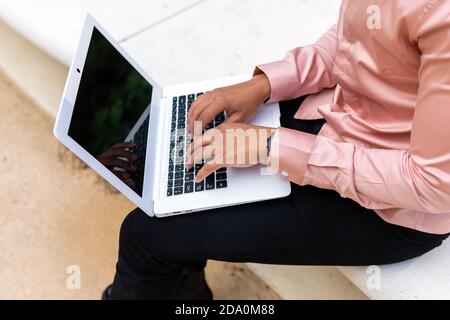 Side view of serene female relaxing in old leather armchair in vintage room with glowing light bulb and looking away Stock Photo