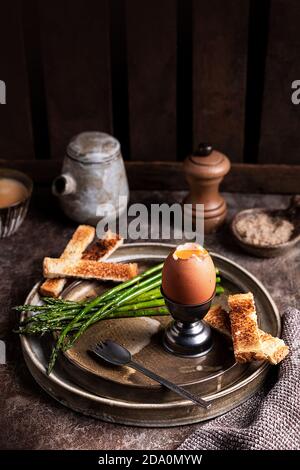 High angle of bread crouton and soft boiled egg yolk served on table in kitchen for breakfast Stock Photo