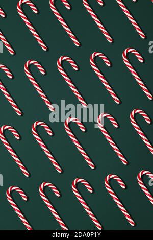 Top view composition with red Christmas candy canes arranged in rows on black background Stock Photo