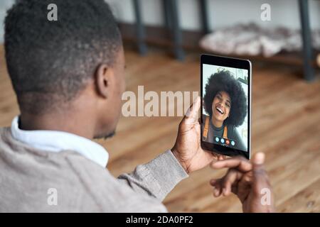 African american man video calling girlfriend on digital tablet. Stock Photo