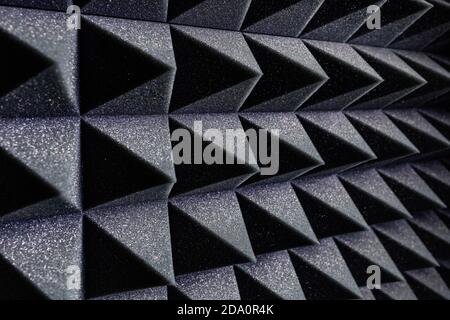 Textured background of wall with black geometric soundproof foam with pyramid shaped pattern in recording studio Stock Photo