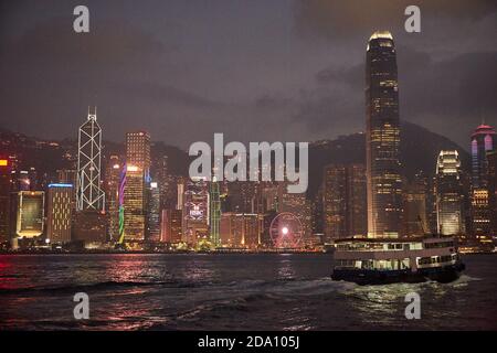 Hong Kong, China, April 2018.Boats sailing in Kowloon bay with Hong Kong skyline in the background at night. Stock Photo