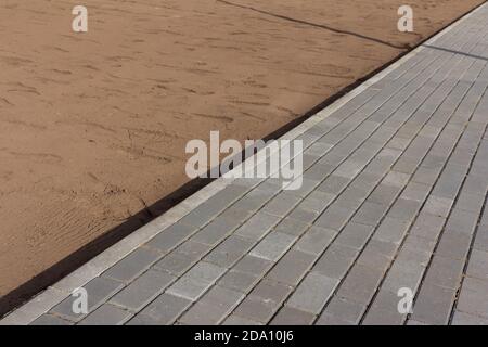 Part of urban street covered with gray concrete cubes Stock Photo