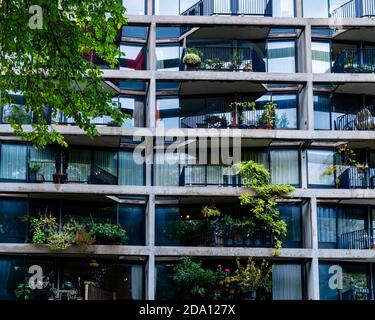 Lush plants and bushes growing on the balconies of the residents of this grey building at the Haarlemmer Houttuinen Stock Photo