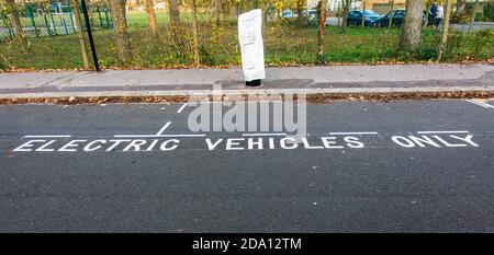Electric vehicles only parking space on roadside next to newly installed Electric charging pods