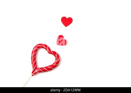 Festive background with hearts and Lollipop on a white concrete background. Stock Photo