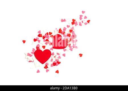 Two red hearts surrounded by small hearts of different colors on a light background. Stock Photo