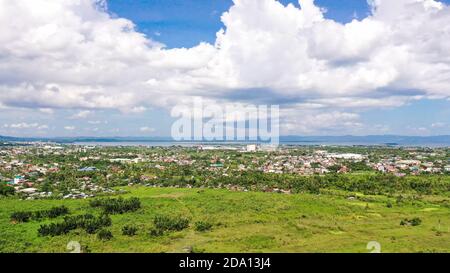 Tropical landscape with panorama of Tacloban, aerial view. Town and sky with cumulus clouds. Leyte Island, Philippines. . Summer and travel vacation concept. Stock Photo