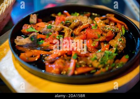 Stewed pork with vegetable on rustic wooden cooking board Stock Photo