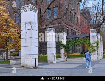 Toronto, Canada - November 5, 2020:  The entrance gate to the main campus of the University of Toronto, with a large old academic building in the back Stock Photo