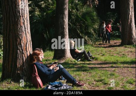 Napoli, Italy. 08th Nov, 2020. A couple sunbathing at the local park in Villa Floridiana. Credit: SOPA Images Limited/Alamy Live News Stock Photo