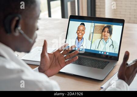 Multicultural doctors team conferencing in video call medical webinar training. Stock Photo