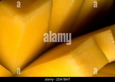 Ripe mango diced close up. Healthy eating with natural products, natural food. Tasty fruit magnified. Stock Photo