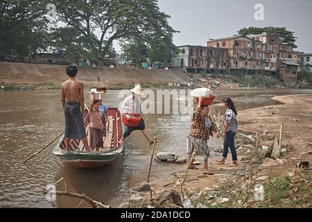 Mae Sot, Thailand. April 2012. Passenger boat crossing the river that serves as the border with Myanmar. Stock Photo