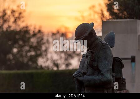 Sunrise on Remembrance Sunday 2020 at the Southend War Memorial. Bronze soldier 'Tommy' sculpture figure in Great War uniform Stock Photo