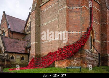 'Fall of Poppies for the Fallen' display of hand-knitted red poppies at Lyndhurst Church during Remembrance Sunday in November 2020, Lyndhurst, UK Stock Photo