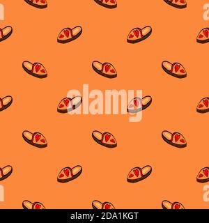 Small slippers , seamless pattern on a orange background. Stock Vector