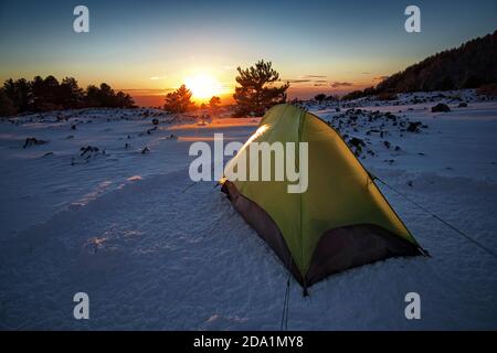 tent on the snow in Etna Park at the sunset, Sicily Stock Photo