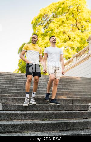 Gay couple holding their hands and walking. Stock Photo