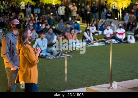 Grand Rapids, Michigan, November 7, 2020: People watch President-elect Joe Biden's victory speech at a watch party in downtown Grand Rapids. Stock Photo