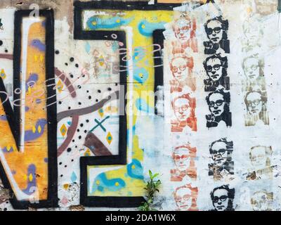 Graffiti with words and a face on a wall at Soi Na Na, Chinatown,  Bangkok, Thailand. Stock Photo