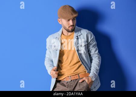 Fashionable young man on color background Stock Photo
