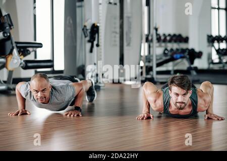 Fit men doing push-ups Stock Photo