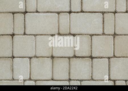 Concrete or cobble gray square pavement slabs or stones for floor, wall or path. Traditional fence, court, backyard or road paving.  Stock Photo