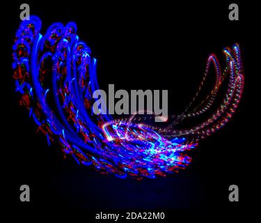 Light painting. Creative shapes created by different light sources. Black background. Abstract ...