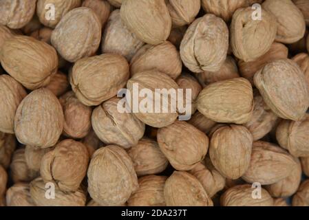 Natural walnut background pattern texture Abstract walnuts heap pattern background Blurred edges frame Natural food Stock Photo