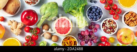 Organic vegan food panorama. Overhead shot of fruits, vegetables, legumes, mushrooms, nuts. Healthy balanced diet concept Stock Photo