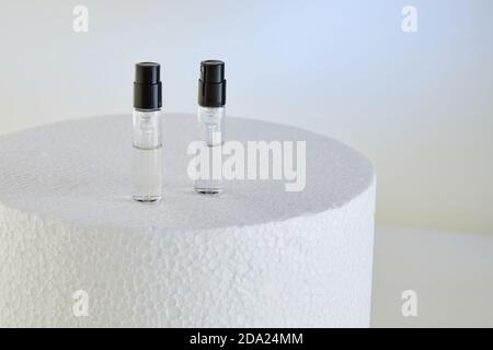 Dropper Bottle for perfume bottles without labels on a white podium. Stock Photo