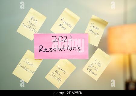 Pasted common 2021 new year resolution written sticky notes on wall. Stock Photo