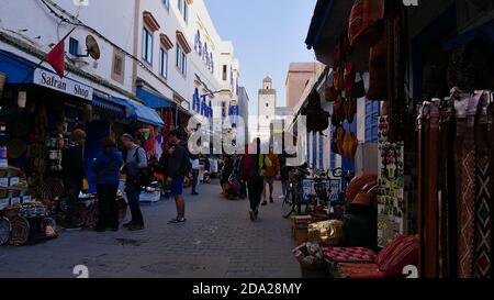 Essaouira, Morocco - 01/04/2020: Busy scene in the narrow market streets of the historic center (Medina) with tourists looking for souvenirs and gifts. Stock Photo