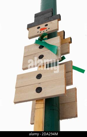 Kotka, Finland - December 13, 2014: Christmas street decoration, snowman made of painted wooden boards mounted on a streetlight pole Stock Photo