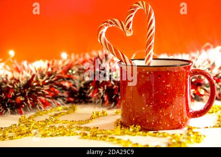 Christmas candy canes in cup on white background Stock Photo - Alamy