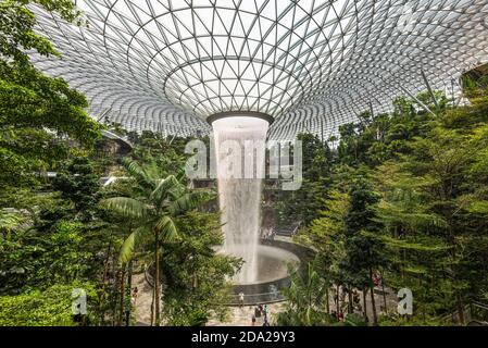 Singapore - December 6, 2019: HSBC Rain Vortex is the largest indoor waterfall in the world located inside the Jewal Changi Airport in Singapore. Stock Photo