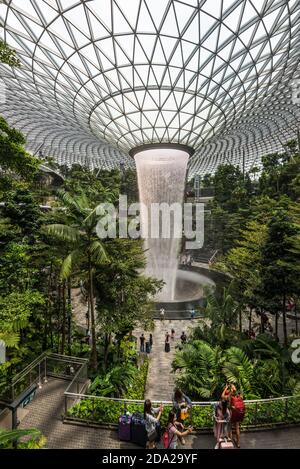 Singapore - December 6, 2019: HSBC Rain Vortex is the largest indoor waterfall in the world located inside the Jewal Changi Airport in Singapore. Stock Photo