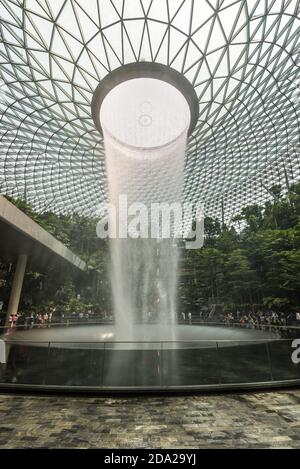 Singapore - December 6, 2019: HSBC Rain Vortex is the largest indoor waterfall in the world located inside the Jewal Changi Airport in Singapore. Stock Photo