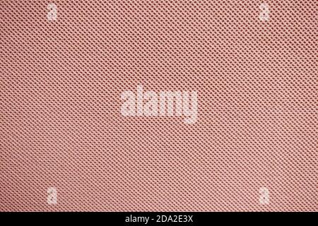 Texture of red fabric with a repeating uniform pattern of dots Stock Photo