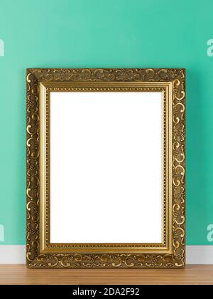 Vertical ornate golden picture frame leaning on green wall mockup template. Blank image area isolated with clipping path Stock Photo